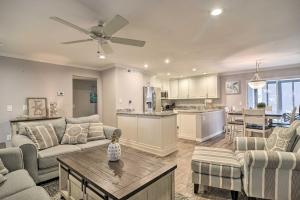 a living room with a couch and a table at Elegant FL Condo with Pool Walk to Madeira Beach! in St. Pete Beach