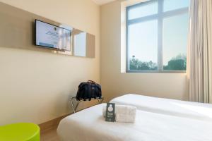 a bedroom with a television and a bed at B&B Hotel Milano San Siro in Milan