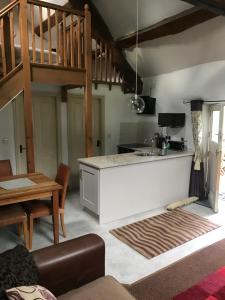 a kitchen with a counter top and a staircase at Tyddyn Bach Barn in Betws-y-coed
