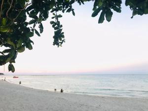 a beach with people swimming in the ocean at PTK BEACH in Chaweng