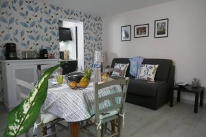 a living room with a table and a couch at T2 à Sérignan Hérault in Sérignan