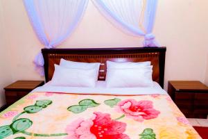 A bed or beds in a room at Kijungu Hill Hotel Hoima