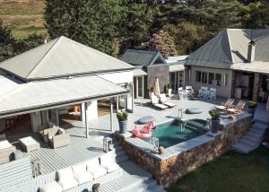 an aerial view of a house with a swimming pool at Qambathi Mountain Lodge - Adults only in Rev Estates