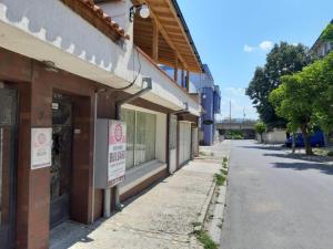 an empty street next to a building at Guest House Bulgari in Kazanlŭk