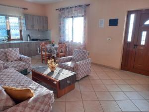 a living room with a couch and a coffee table at Jonny Guesthouse in Ksamil