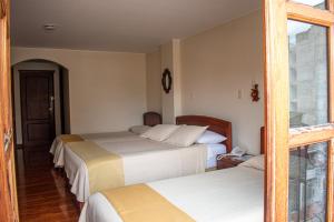 Hotel Dinastia Real客房内的一张或多张床位