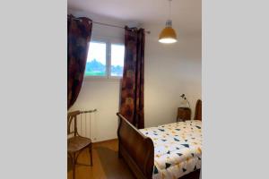 a bedroom with a bed and a window at Villa Carrelous in Saint-Gaudens +4 photos