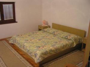 a bedroom with a bed and a table with a lamp at APARTMENTS Vuković in Vrboska +11 photos