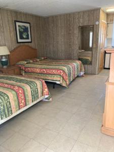 a hotel room with two beds and a mirror at Glendale Motel in Seaside Heights