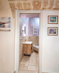 a bathroom with a sink and a toilet at C'era una Volta Apartments in Polignano a Mare +41 photos