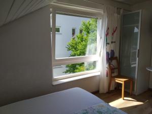 1 dormitorio con cama y ventana en Ferienwohnung Wiedmann, en Tübingen