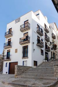 a white building with stairs in front of it at Casa Juanita in Peniscola