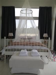 - un lit blanc dans une chambre avec fenêtre dans l'établissement Spacious Beach House Theologos, à Theologos