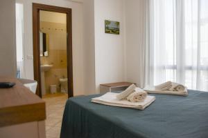 a room with a blue table with towels on it at Hotel Sikania in San Vito lo Capo