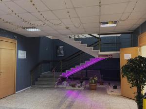 a staircase in a building with purple lighting at Hostel on Komsomolskaya in Sochi