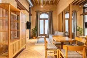 a living room with a table and a couch at Santa Clara Suites Sevilla in Seville