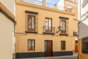 a building with windows and balconies on a street at Santa Clara Suites Sevilla in Seville