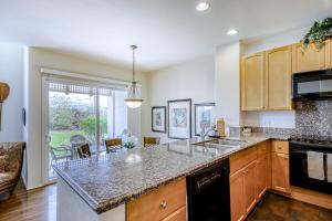 a kitchen with wooden cabinets and a counter top at Waikoloa Colony Villas 1703 in Waikoloa