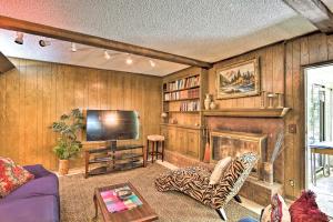 a living room with a tv and a fireplace at Private Home with Hot Tub and Patio Near Dtwn Tulsa in Tulsa