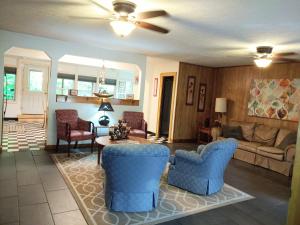 a living room with blue chairs and a couch at Stony Creek Motel in Maggie Valley