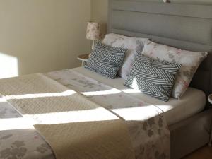 a bed with pillows on it in a bedroom at Holiday Home with Sea View in Vrbnik