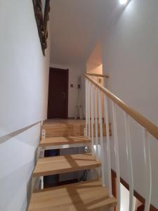 a staircase with wooden risers in a house at Cuscino e Cappuccino B&B in Alghero