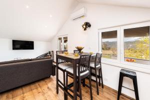 a living room with a table and chairs and a couch at Nerona in Bisko