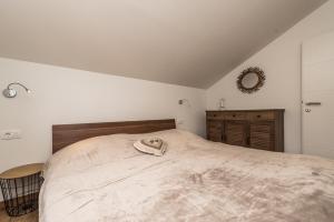 a bedroom with a large bed with a hat on it at Nerona in Bisko +37 photos