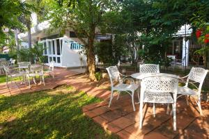 a group of chairs and a table in a yard at Milano Tourist Rest in Anuradhapura