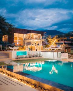 a villa with a swimming pool at night at Tunas & Cabras Hotel in Ibarra