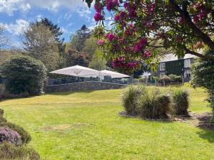 a house with a white tent in a field at Aberdunant Hall Holiday Park in Porthmadog