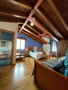 a bedroom with a bed and a couch in a room at LA CASONA DE RALES VILLAVICIOSA in Rales