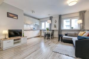 a living room with a couch and a table at Vienības Studio in Jūrmala