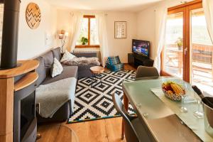 a living room with a couch and a table at Ferienhaus "Am Wäldle" in Feldberg