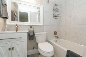 a white bathroom with a toilet and a sink and a tub at Siesta Key Village-Suite #3: A Block to the Beach! in Sarasota +25 photos