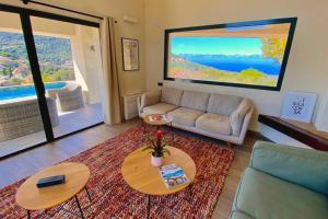 un salon avec un canapé et une table dans l'établissement VILLA CORSA**** PISCINE VUE MER PANORAMIQUE, à Santa-Reparata-di-Balagna