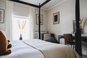 A bed or beds in a room at The Wild Hare Tintern