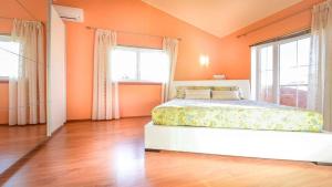 a bedroom with orange walls and a bed and windows at Villa Duda - A Unique Memory in Vodnjan +31 photos