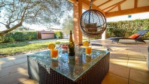 a patio with a table with two candles and a swing at Villa Duda - A Unique Memory in Vodnjan