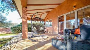 a patio with a swing on a house at Villa Duda - A Unique Memory in Vodnjan