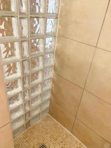 a shower with clear glass shelves in a bathroom at CASA A CERTOSA au cœur de la Citadelle in Bastia +41 photos
