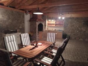 a dining room with a wooden table and chairs at Tomić in Novi Vinodolski +19 photos