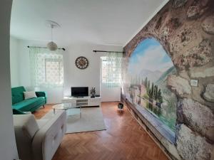 a living room with a large stone wall at Old Town Heart in Kotor