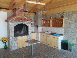 a kitchen with a stone fireplace and a stove at Tomić in Novi Vinodolski