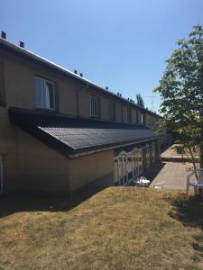 a building with a solar roof on the side of it at Skuldelev kro in Skibby