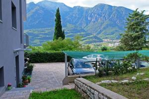 a couple of cars parked in a driveway with mountains at In Collina B&B in Trento
