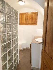 a kitchen with a wall of glass block tiles at CASA A CERTOSA au cœur de la Citadelle in Bastia