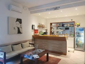 a living room with a couch and a bar at Hotel Bellini in Riccione