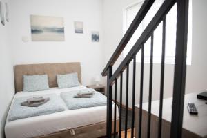 a bedroom with a bed with two towels on it at APARTMAN TEA 2 in Belgrade