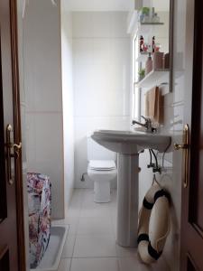 a bathroom with a sink and a toilet at Vivienda Vacacional El Acebo - Cudillero in El Pito